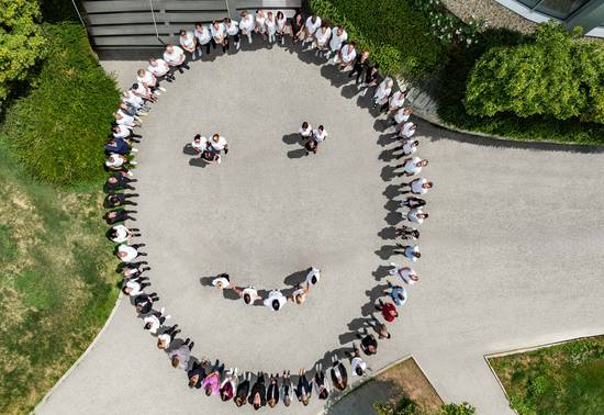 REDUCE employees form a smiling smiley face